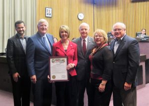 United Through Reading CEO and Board Trustees accept a proclamation from the San Diego County Board of Supervisors. Left to right: Charlie Van Vechten; Supervisor Greg Cox; Sally Ann Zoll, Ed.D.; Dwayne N. Junker, USN (Ret); Deborah L. Bell, USAF (Ret); and RADM Fran Holian, USN (Ret).